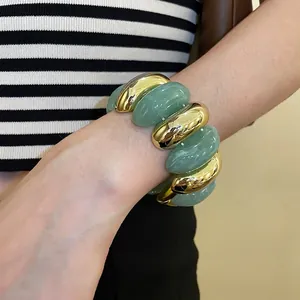 Chunky gold metal and green acrylic oval link bracelet for modern fashion styling