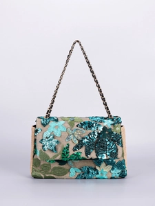 Detail of embroidered floral sequins and chain strap on a woven linen shoulder bag