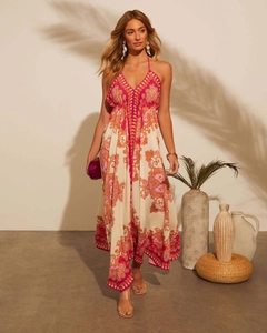 Macro detail of V-neck halter maxi dress featuring vibrant pink paisley prints and pleats