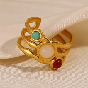 Macro detail of 18K gold plated double layer ring with green, white and red zircon stones