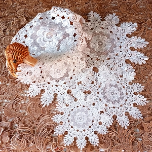 Set of white lace round embroidered coasters with floral crochet cutout details