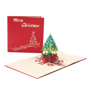 3D pop-up Christmas card with a green paper-cut tree and red gift boxes on white background