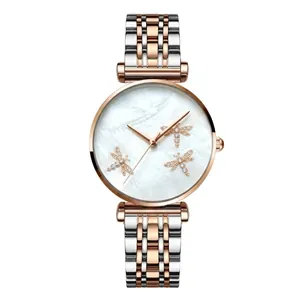 Detail of mother of pearl watch face with rose gold bee accents and mesh strap
