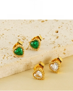 Close-up of heart-shaped zircon earrings in green and white with 18K gold plating