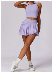 Detail of lavender athletic polo top and high-waisted pleated tennis skirt set
