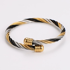 Detailed macro view of the tri-color braided cable bracelet with gold threaded spherical ends