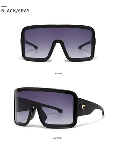 Macro shot of oversized square sunglasses with gold temple logo and gradient purple lens