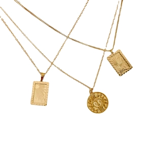 Vintage gold sun pendant necklaces featuring square and round charms on gold chains
