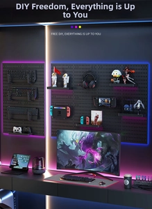 Modular black pegboard for gaming gear wall storage with headset hooks and tray