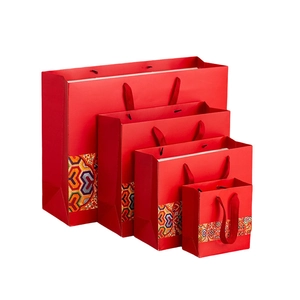 Set of four red Chinese style gift bags with traditional colorful geometric patterns