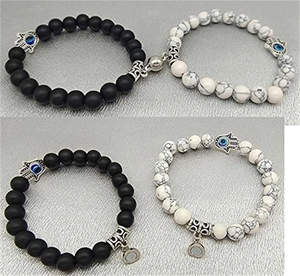 Detail of magnetic stone bracelets for couples with Hamsa hand charms and blue eye accents