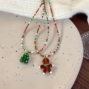 Christmas beaded necklaces with colorful beads featuring Christmas tree and gingerbread man pendants