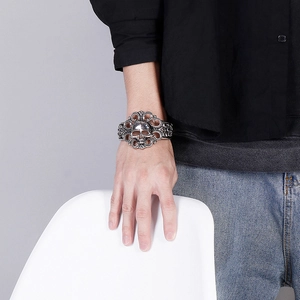 Détail du bracelet manchette gothique argenté avec relief de crâne et motifs ajourés