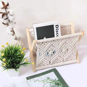Detail of bohemian magazine rack featuring hand-woven cotton rope and wooden frame