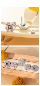 Macro detail of square zircon stud earrings with radiant cut stones and screw backs