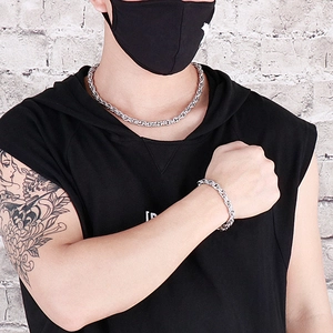 Silver stainless steel snake chain necklace and bracelet set worn by a male model