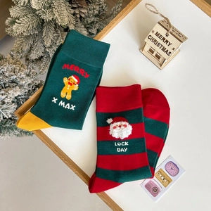 Close-up of festive Christmas crew socks with gingerbread and Santa Claus motifs