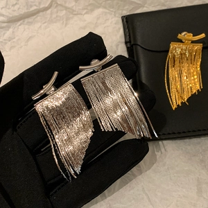 Sleek long metal tassel earrings with curved bar design in gold and silver finishes