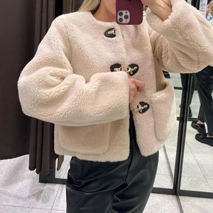 Giacca corta in pile sherpa crema da donna con fibbie metalliche e finiture in pelle