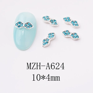 Detailed view of blue rhinestone bow nail charms with silver metal base and sizing