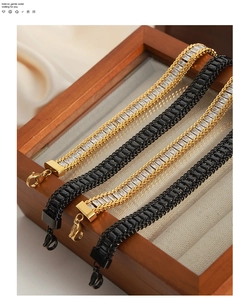 Close-up of geometric titanium bracelets with rectangular zircon and braided metal chains
