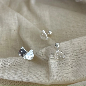Polished 925 sterling silver bear stud earrings with screw backs on soft beige fabric