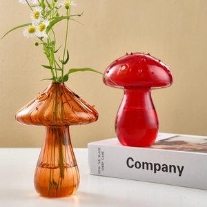 Cute mushroom-shaped glass vases in orange and red for home floral decoration