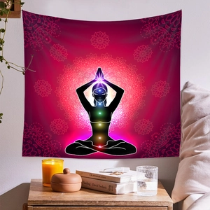 Detail of yoga meditation tapestry featuring seven chakras and mandala texture on wall