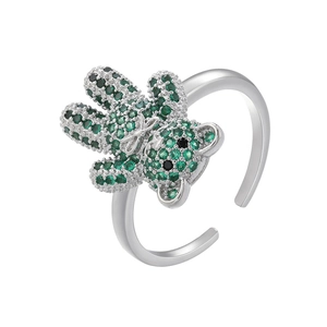 Detail of silver bear ring with green gemstone pavé and sparkling bow tie accent