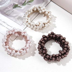Set of 3 elegant faux pearl elastic hair ties in white, pink, and brown for women