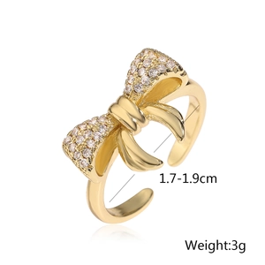 Detailed view of golden bow ring with cubic zirconia and 1.7-1.9cm size specs