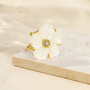 Vintage 18K gold plated butterfly flower ring with pearl on beige stone surface