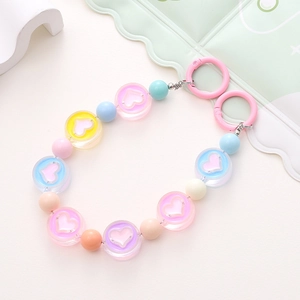 Close-up of macaron acrylic beaded phone chain with heart charms and pink clips
