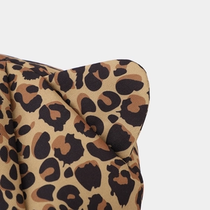 Close-up of leopard print fabric texture and 3D cat ear detail on a baker boy cap