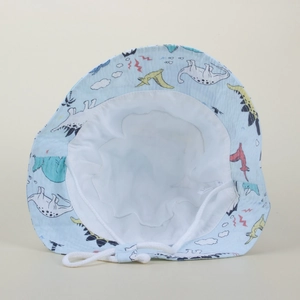 Detail view of baby sun hat with blue dinosaur print, soft lining, and white chin strap
