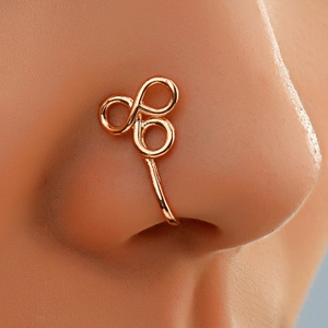 Macro shot of rose gold triple-intertwined geometric non-piercing U-shaped nose cuff
