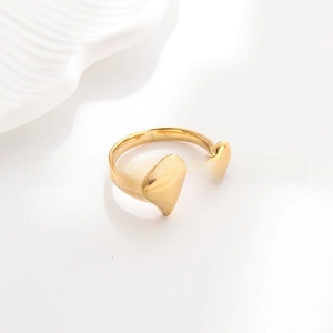 Close-up of golden double heart open ring made of polished 18k gold plated titanium steel