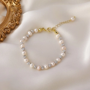 Detail of 14K gold plated baroque pearl bracelet with sparkling spacer beads and chain