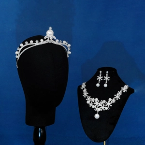 Exquisite bridal jewelry set with silver crown, necklace and earrings on a black mannequin