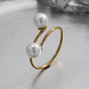 Detailed view of dual white pearls on a spiral 18K gold-plated stainless steel ring band