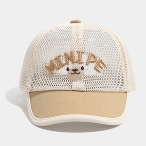 Detailed macro view of children's mesh sun hat featuring a cute bear embroidery