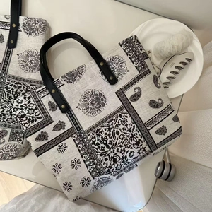 Retro paisley print linen tote bag with black leather handles and floral patterns