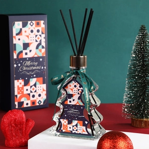 Christmas tree reed diffuser gift set in glass bottle with festive packaging and green ribbon