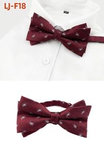Detail of burgundy paisley bow tie featuring dual-layer structure and jacquard texture