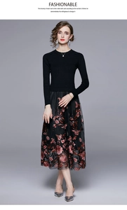 Detail of red floral embroidery on black mesh skirt of a vintage patchwork dress