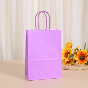 Close-up of a light purple paper gift bag with a matching twisted rope handle for shopping