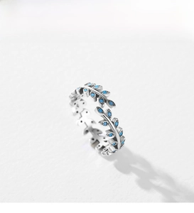 Macro detail of leaf-shaped silver ring with turquoise inlay and vintage finish