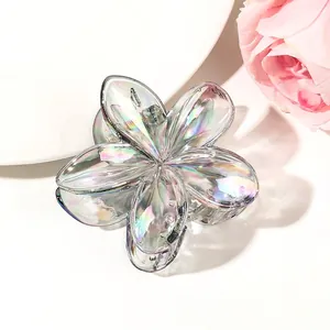 Detailed macro view of holographic gradient flower hair claw clip with transparent texture