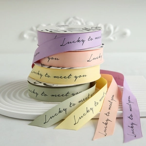 Close-up of candy-colored decorative ribbons with 'Lucky to meet you' printed text