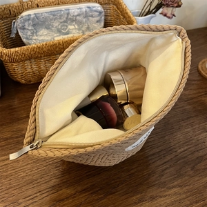 Macro view of woven cosmetic bag with large storage space for skincare products